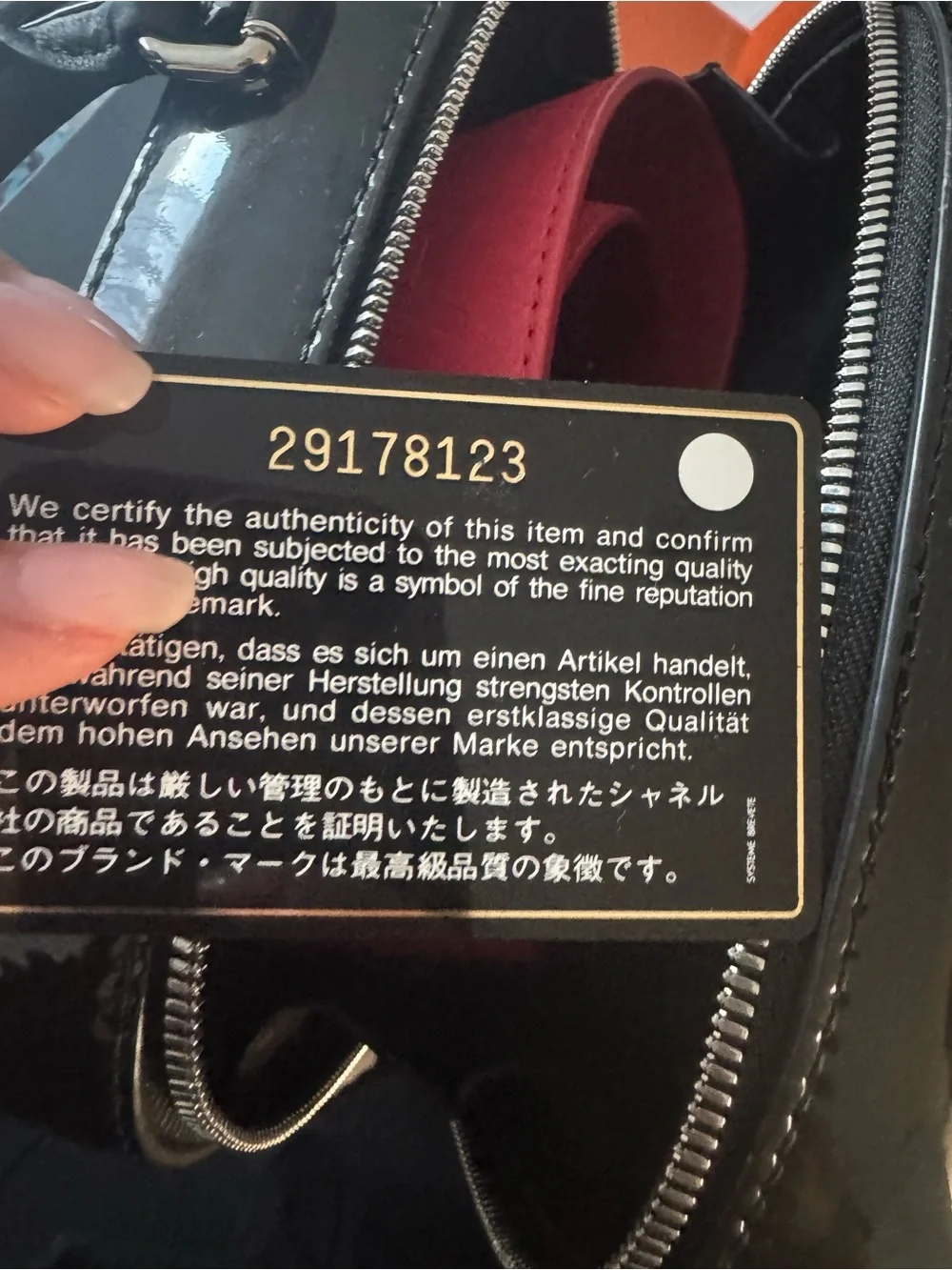 CHANEL Black Quilted Patent Top Handle Vanity Bag with red strap